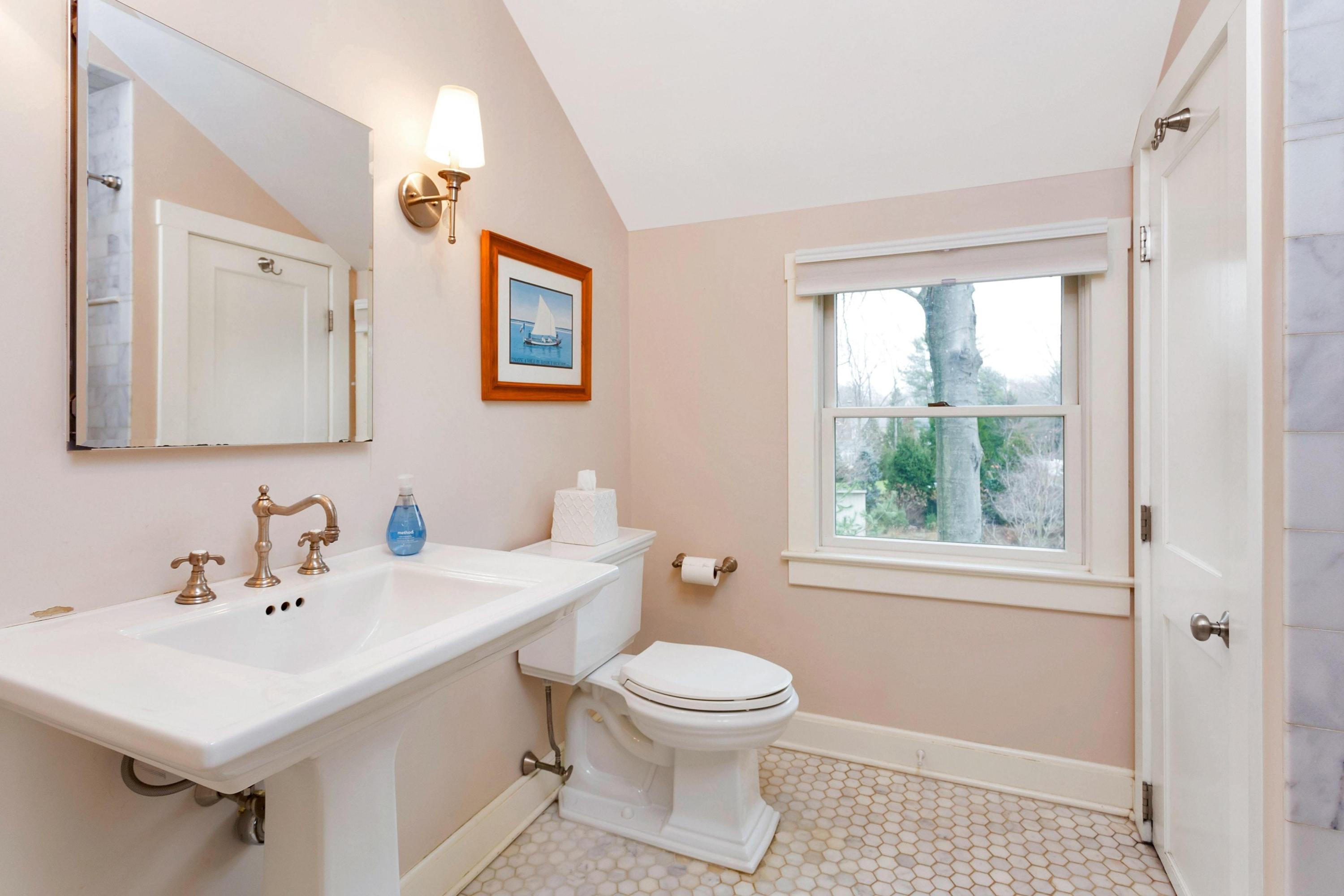 227 Middlesex Road Darien, CT 06820 - Photo 19 of 30 a bathroom with a toilet a sink a mirror and a window