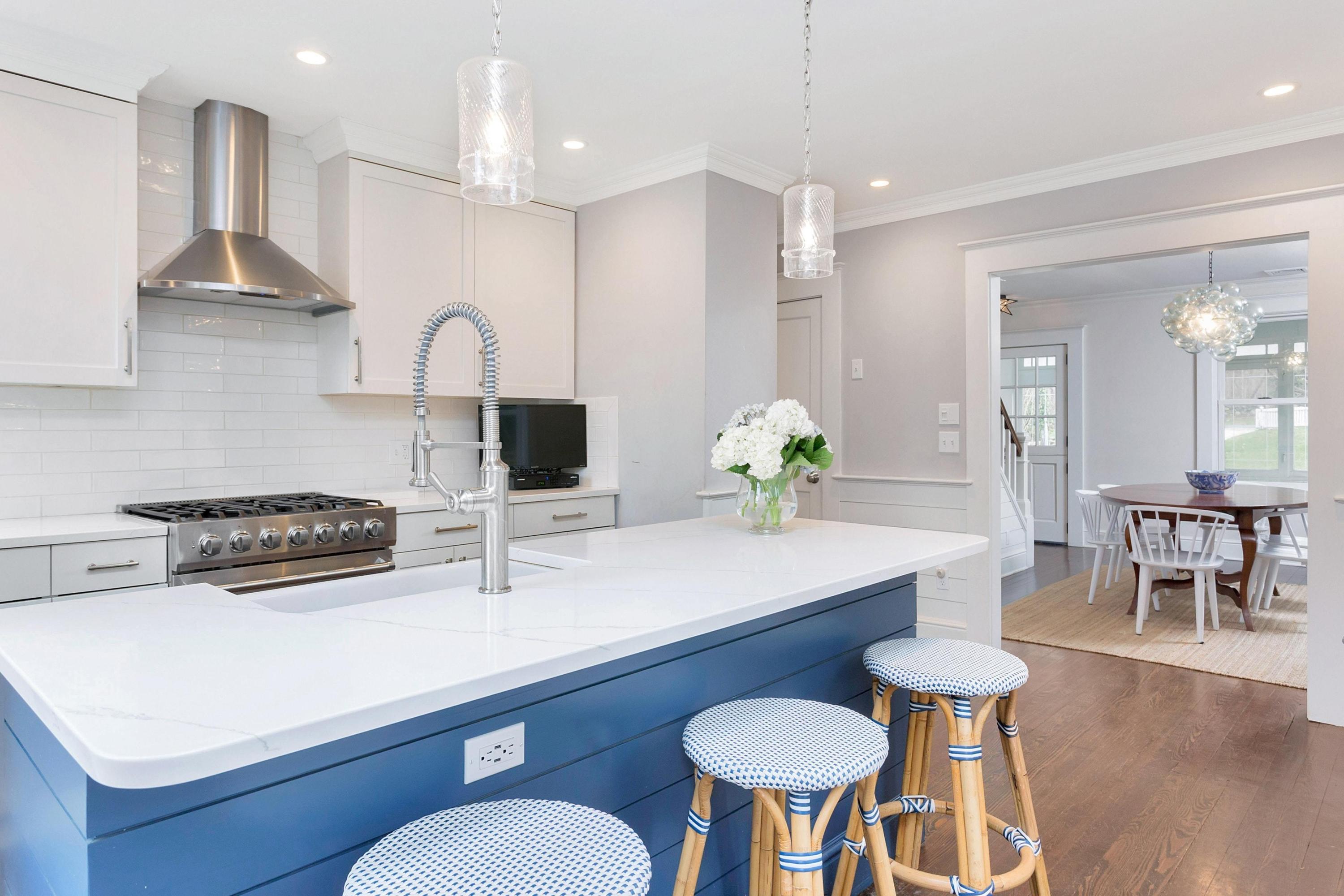 227 Middlesex Road Darien, CT 06820 - Photo 8 of 30 a kitchen with stainless steel appliances a dining table and chairs