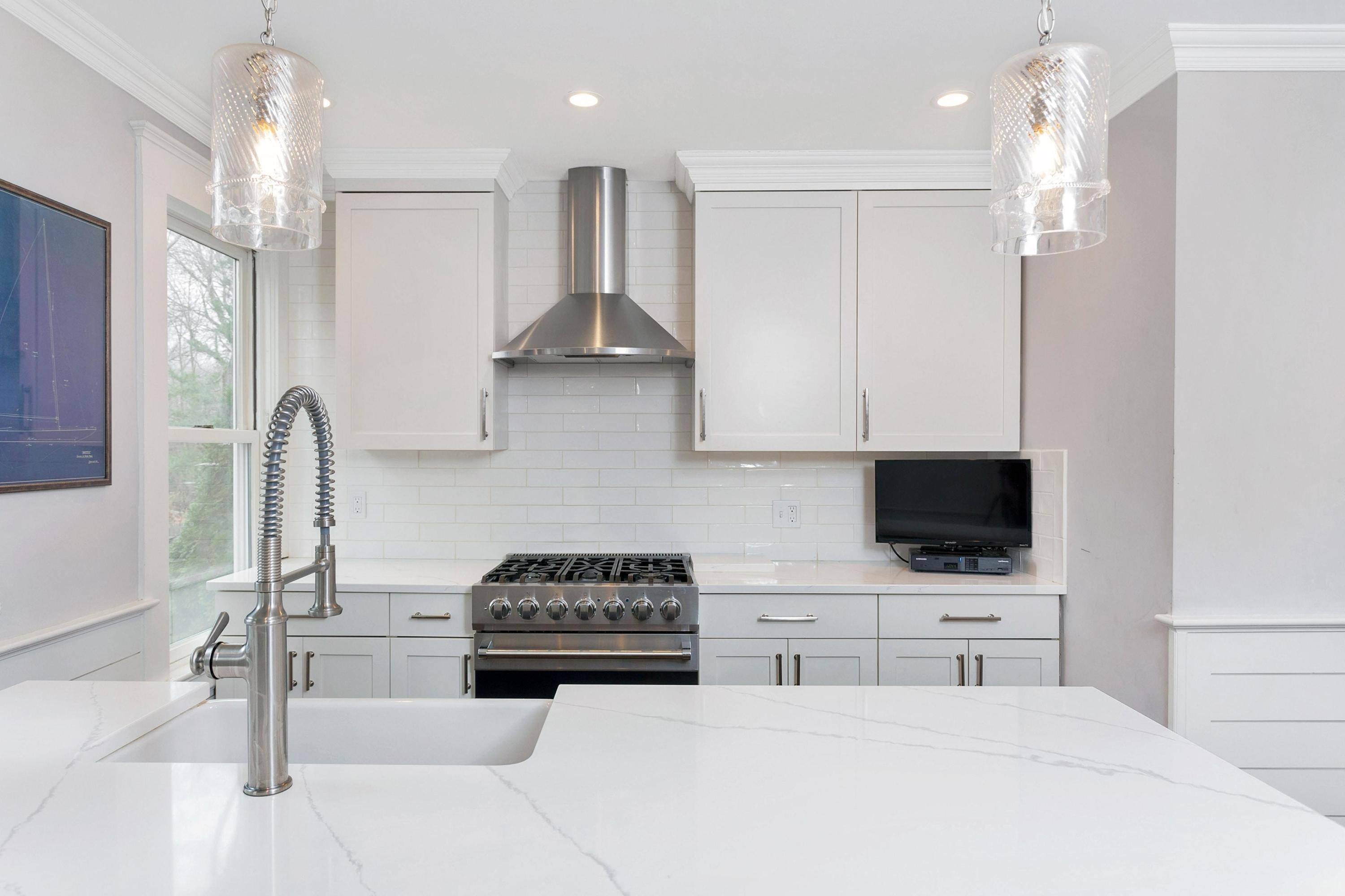 227 Middlesex Road Darien, CT 06820 - Photo 10 of 30 a kitchen with stainless steel appliances a stove a sink and a microwave