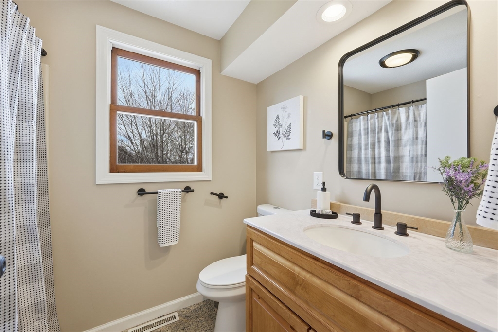 10 Woodcrest Road Springfield, MA 01129 - Photo 16 of 26 a bathroom with a sink a toilet and mirror