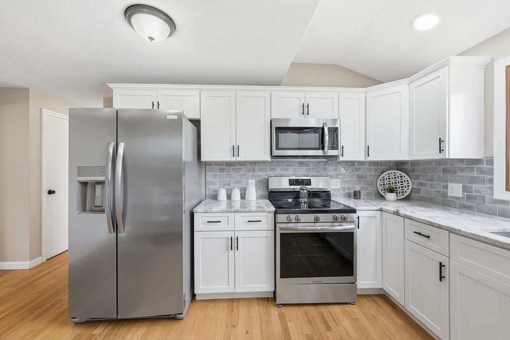 10 Woodcrest Road Springfield, MA 01129 - Photo 8 of 26 a kitchen with cabinets stainless steel appliances a sink and wooden floor