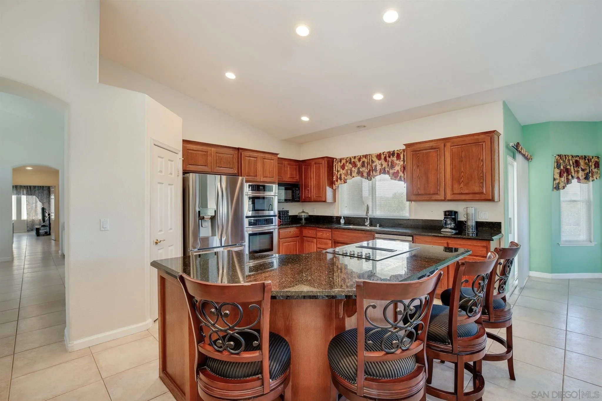 31210 Rivoli Road Valley Center, CA 92082 - Photo 11 of 62 a kitchen with stainless steel appliances granite countertop a sink and a refrigerator