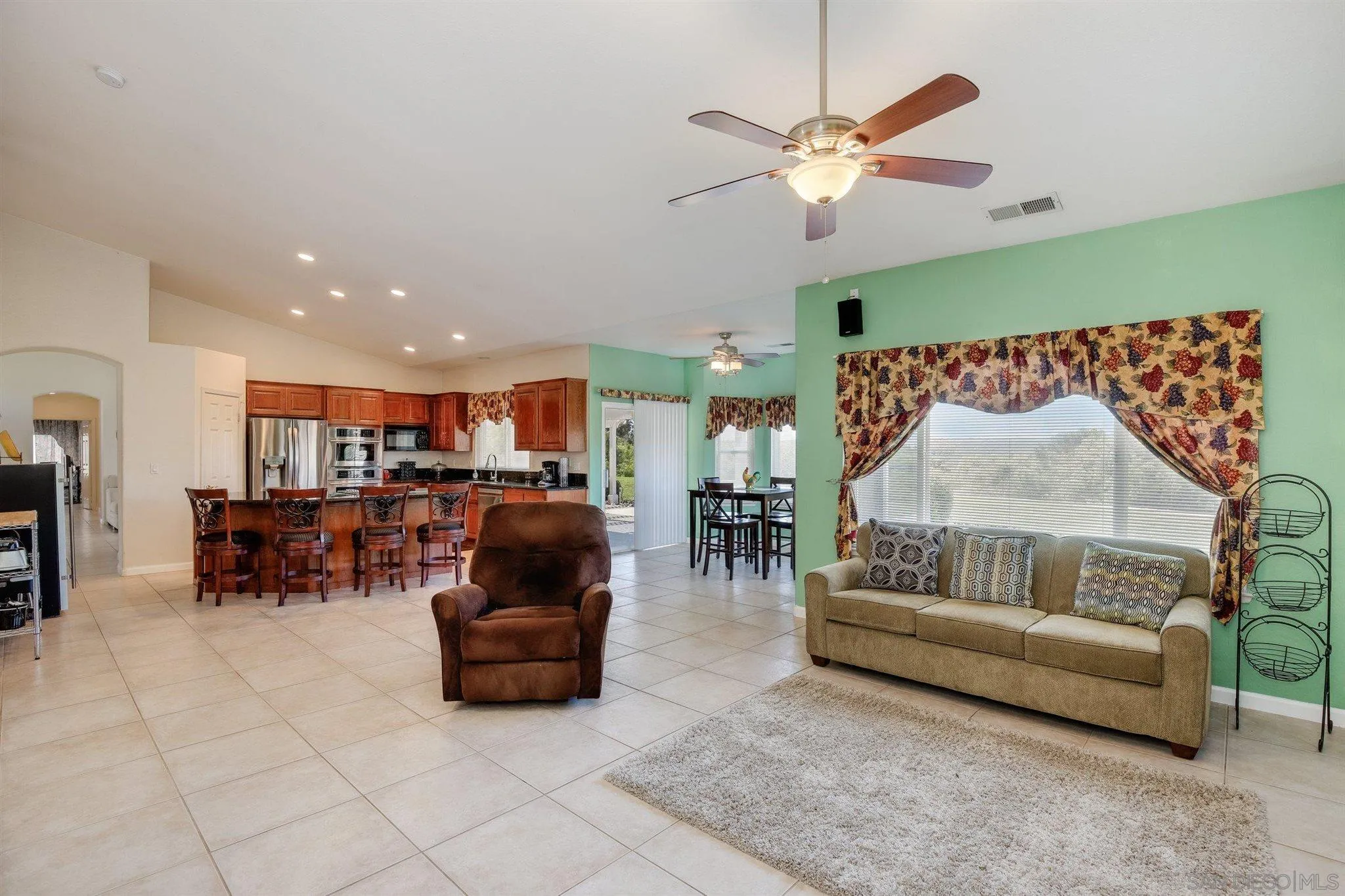31210 Rivoli Road Valley Center, CA 92082 - Photo 16 of 62 a living room with furniture and a ceiling fan