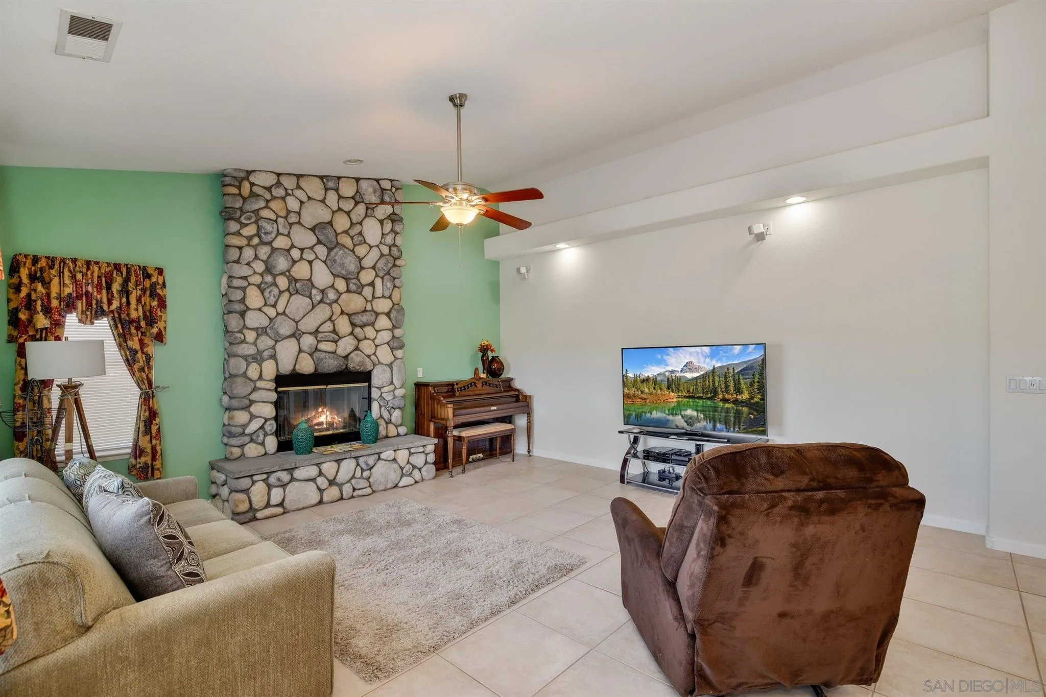 31210 Rivoli Road Valley Center, CA 92082 - Photo 18 of 62 a living room with furniture and a fireplace