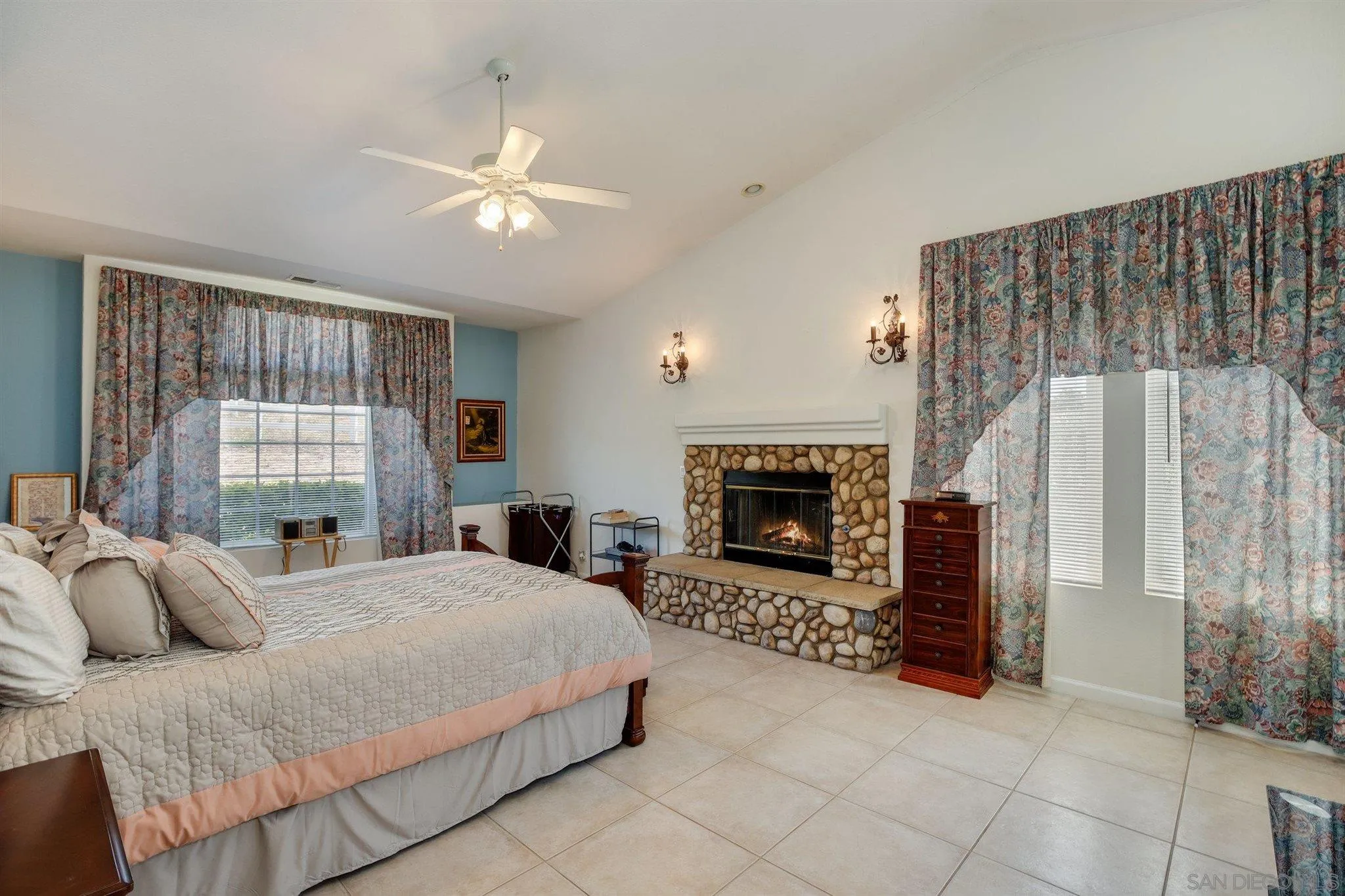 31210 Rivoli Road Valley Center, CA 92082 - Photo 20 of 62 a spacious bedroom with a bed and a fireplace