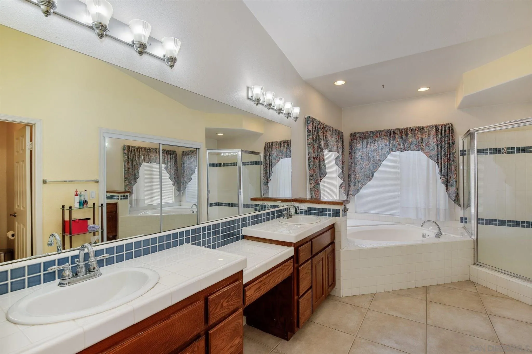 31210 Rivoli Road Valley Center, CA 92082 - Photo 23 of 62 a spacious bathroom with a sink double vanity granite and a mirror