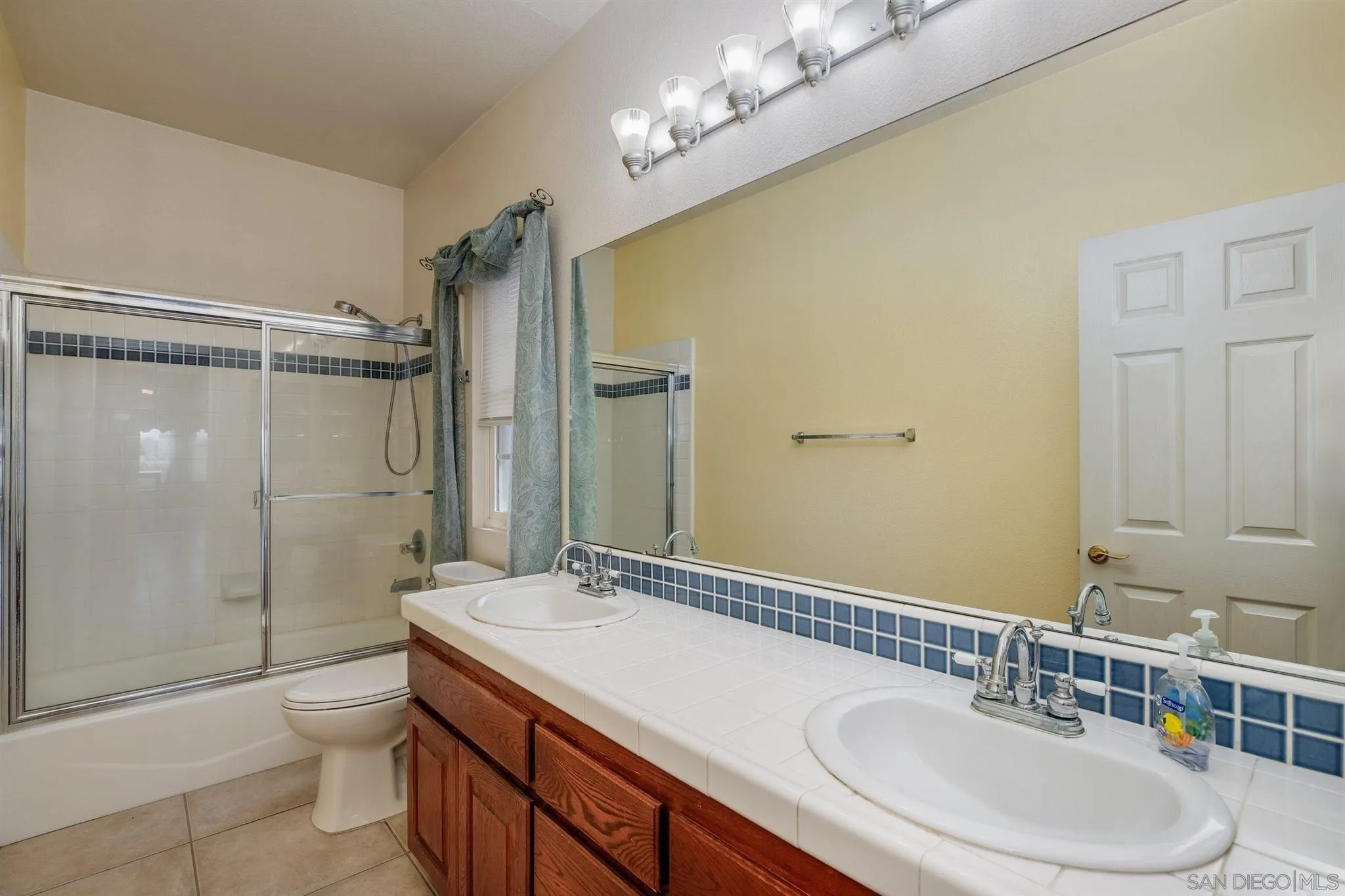 31210 Rivoli Road Valley Center, CA 92082 - Photo 25 of 62 a bathroom with a granite countertop sink toilet a mirror and shower