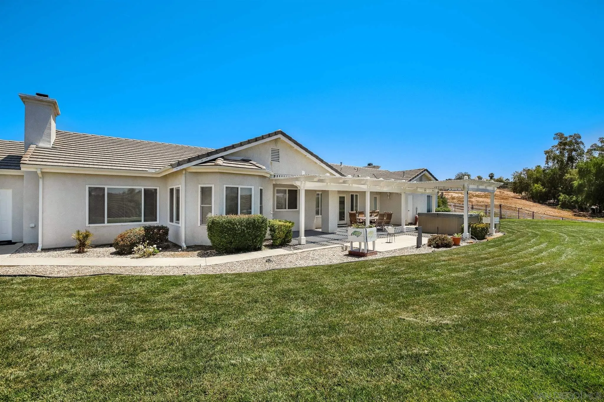 31210 Rivoli Road Valley Center, CA 92082 - Photo 30 of 62 a front view of a house with swimming pool and porch