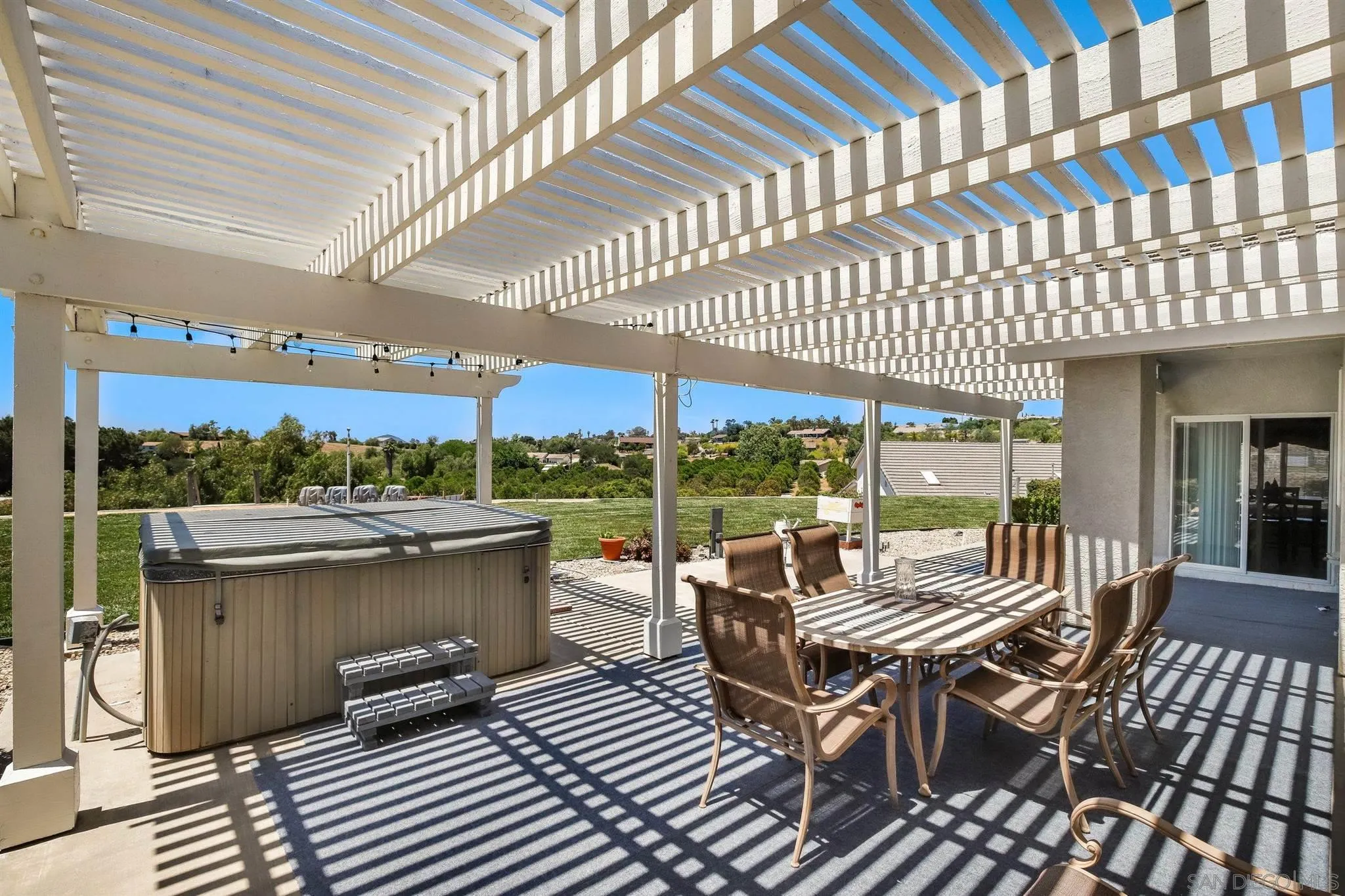 31210 Rivoli Road Valley Center, CA 92082 - Photo 36 of 62 a view of a patio with a dining table and chairs with wooden floor