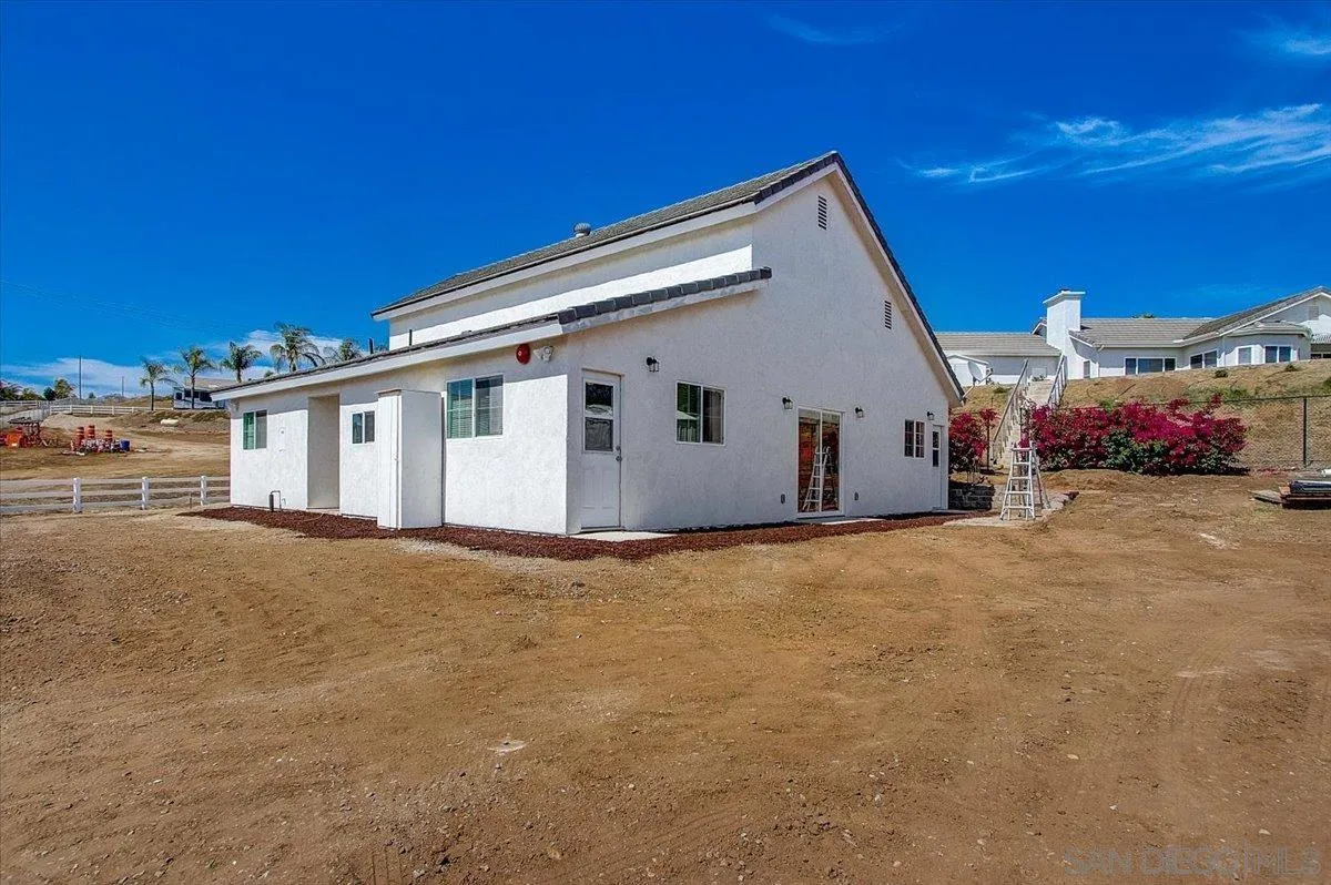 31210 Rivoli Road Valley Center, CA 92082 - Photo 41 of 62 a view of a white house with a yard
