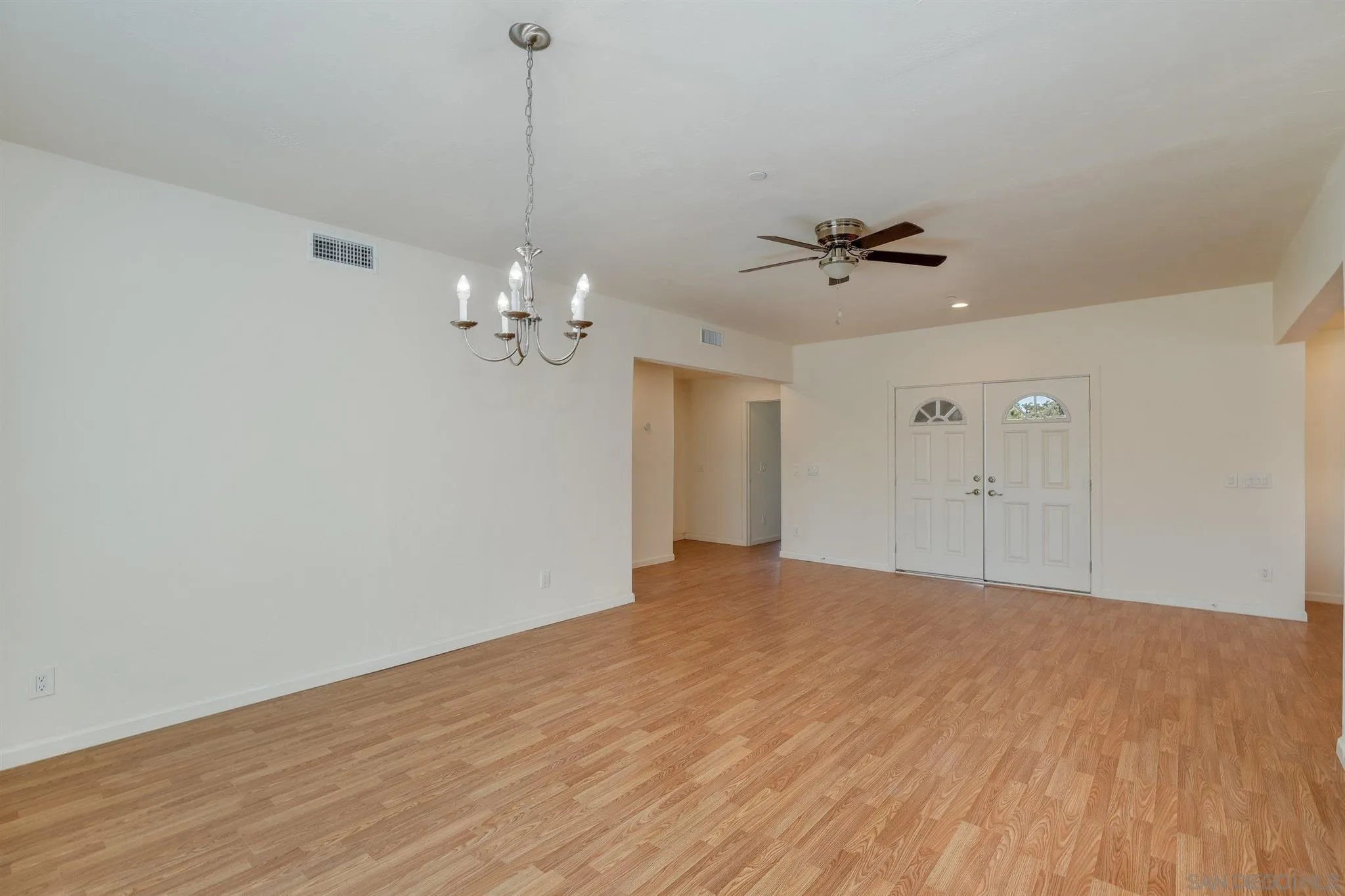 31210 Rivoli Road Valley Center, CA 92082 - Photo 44 of 62 a view of a room with a ceiling fan a ceiling fan and a wooden floor