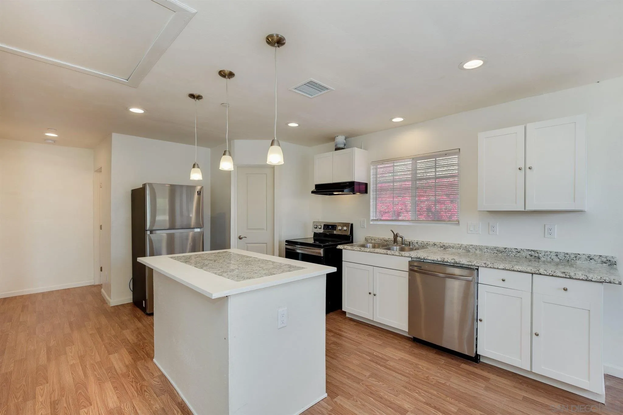 31210 Rivoli Road Valley Center, CA 92082 - Photo 48 of 62 a kitchen with a sink stove and cabinets