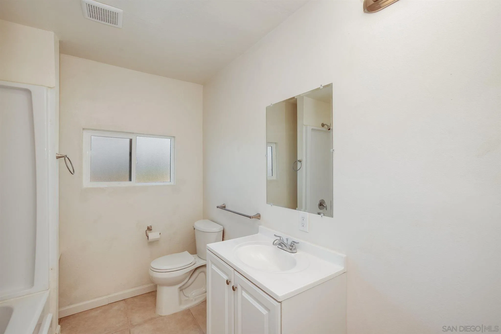 31210 Rivoli Road Valley Center, CA 92082 - Photo 51 of 62 a bathroom with a toilet sink and mirror