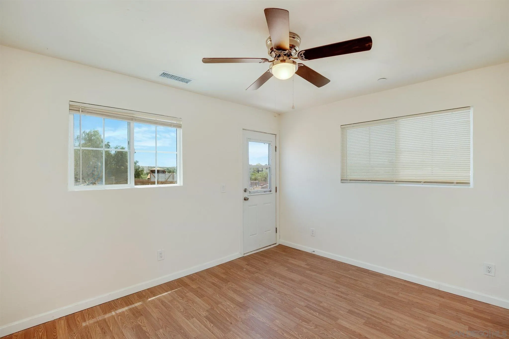 31210 Rivoli Road Valley Center, CA 92082 - Photo 54 of 62 a view of empty room with wooden floor and fan