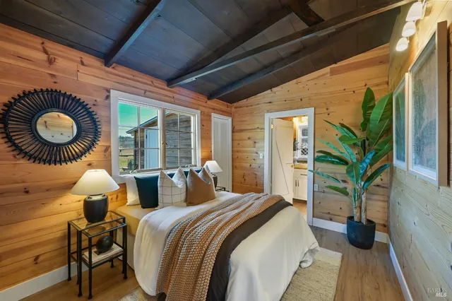 a bedroom with bed and a large window