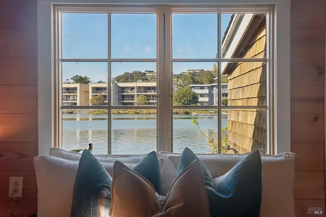 a living room filled with furniture and windows