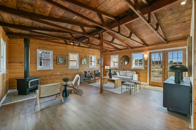 a living room with lots of furniture and wooden floors
