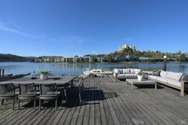 a terrace with outdoor seating and water view