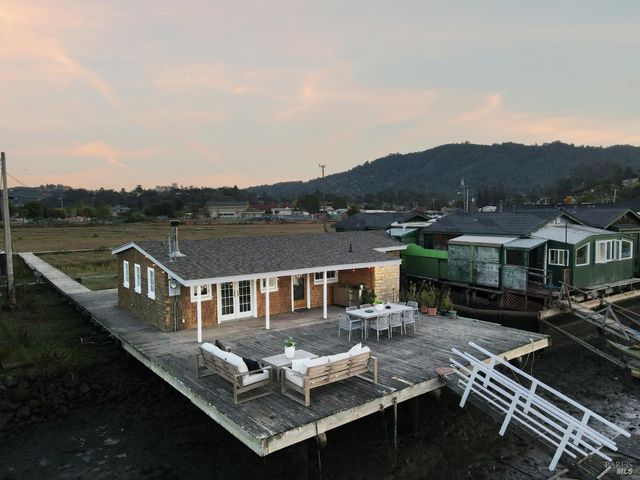 an aerial view of a house with a ocean view