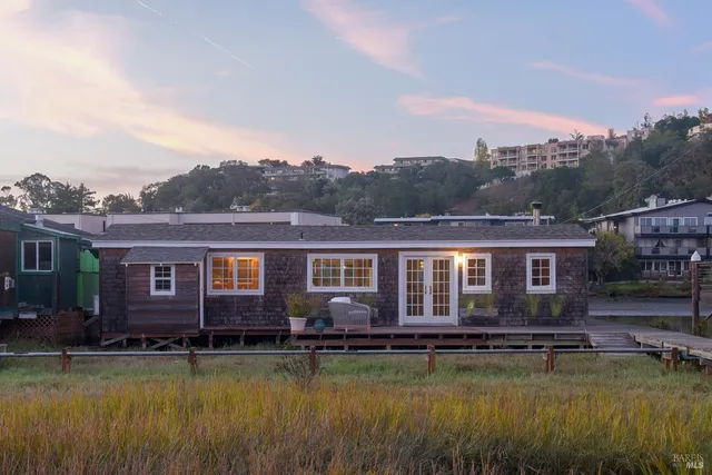 a view of a lake with a big yard and large trees