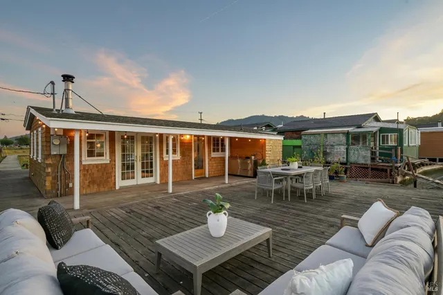 swimming pool view with a couch and wooden floor