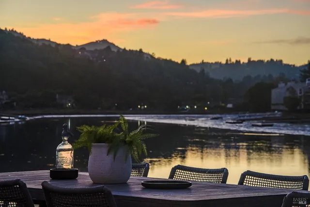 a view of balcony with two chairs and a potted plant