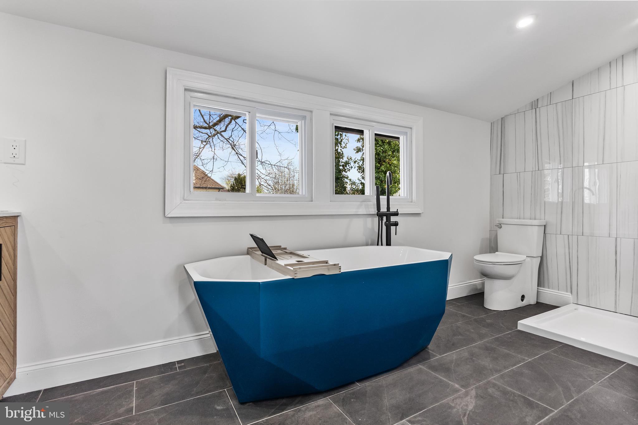 1013 Stone Road Laurel Springs, NJ 08021 - Photo 29 of 42 a spacious bathroom with a bathtub and mirror