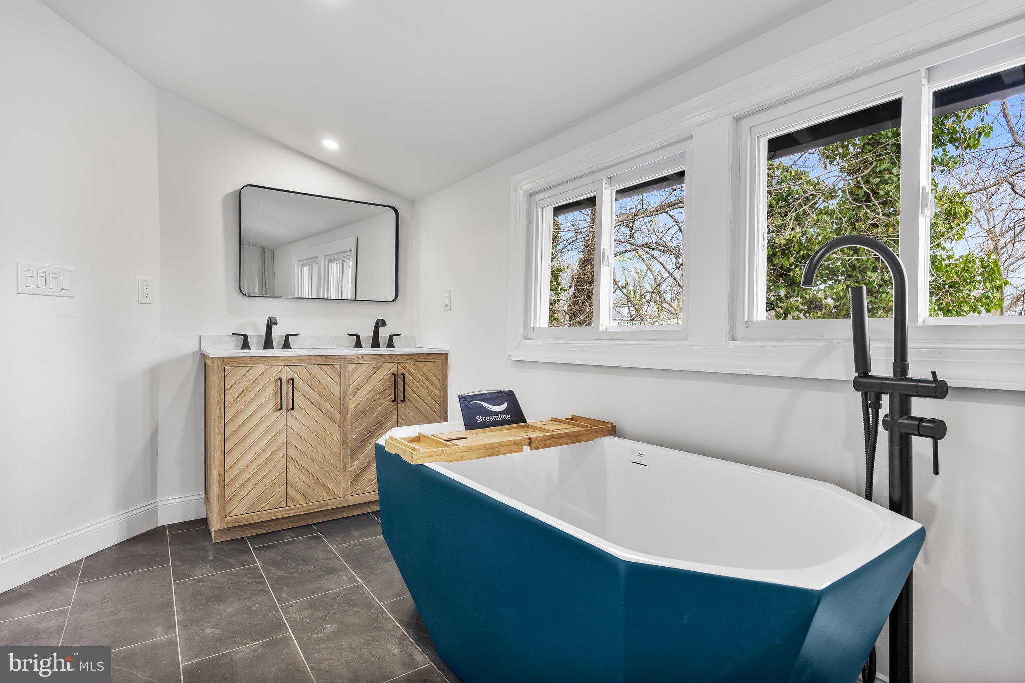 1013 Stone Road Laurel Springs, NJ 08021 - Photo 30 of 42 a white bath tub sitting in a bathroom next to a window