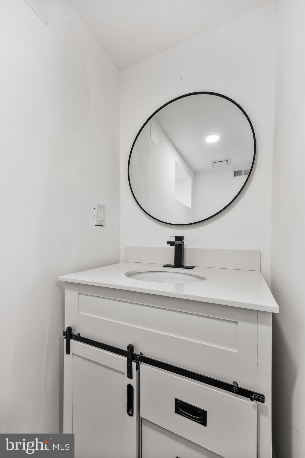 1013 Stone Road Laurel Springs, NJ 08021 - Photo 33 of 42 a bathroom with a sink and mirror