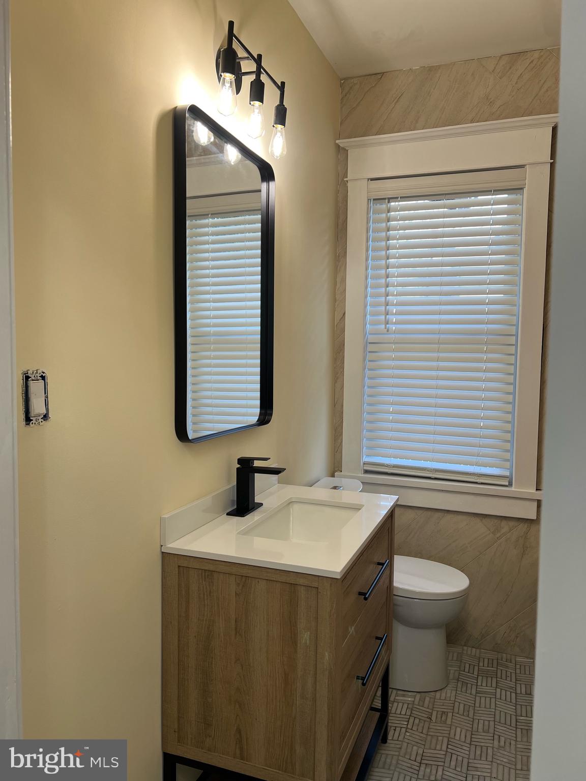 1013 Stone Road Laurel Springs, NJ 08021 - Photo 40 of 42 a bathroom with a sink a toilet and mirror