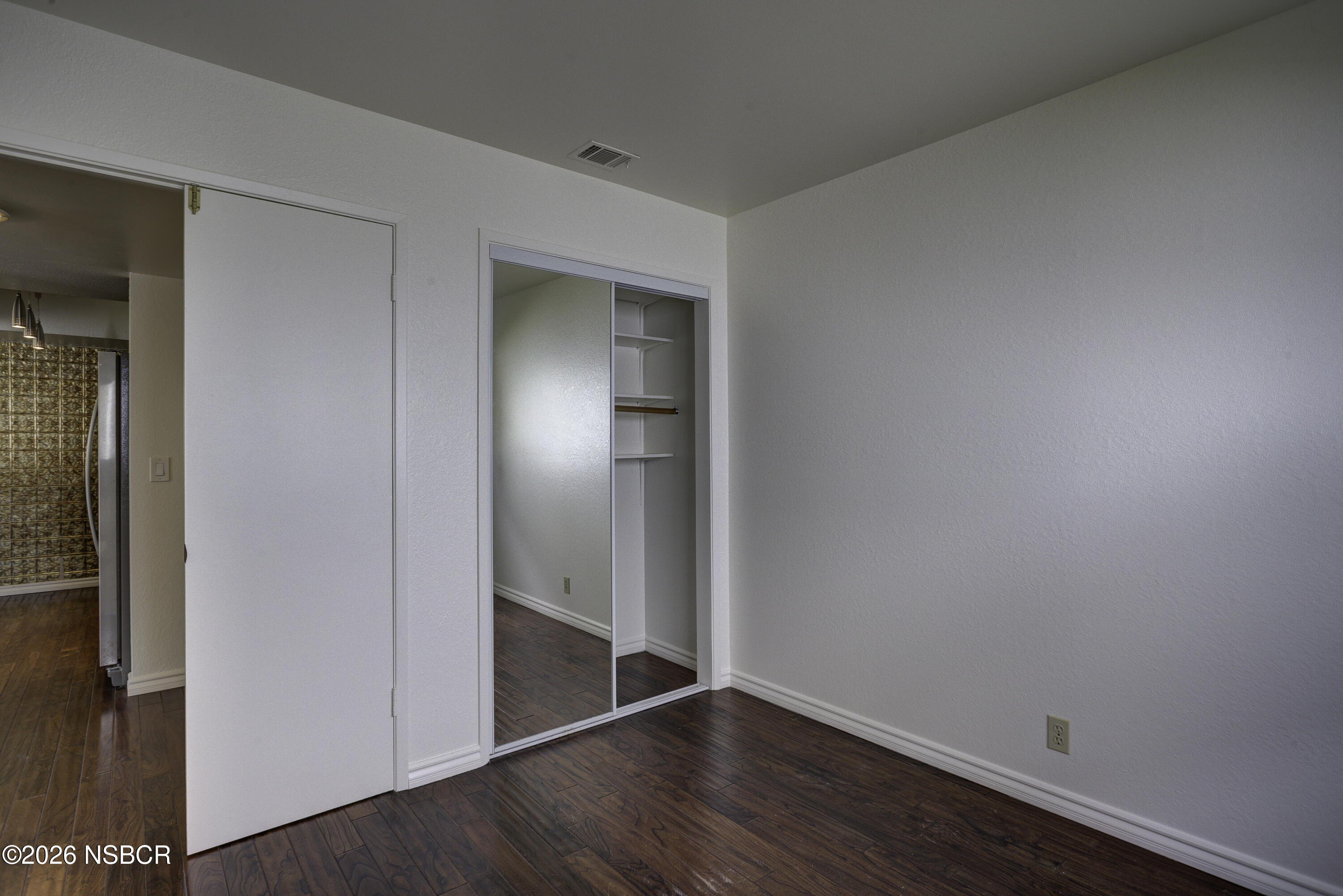 1213 Iris Court Lompoc, CA 93436 - Photo 11 of 21 an empty room with wooden floor and closet