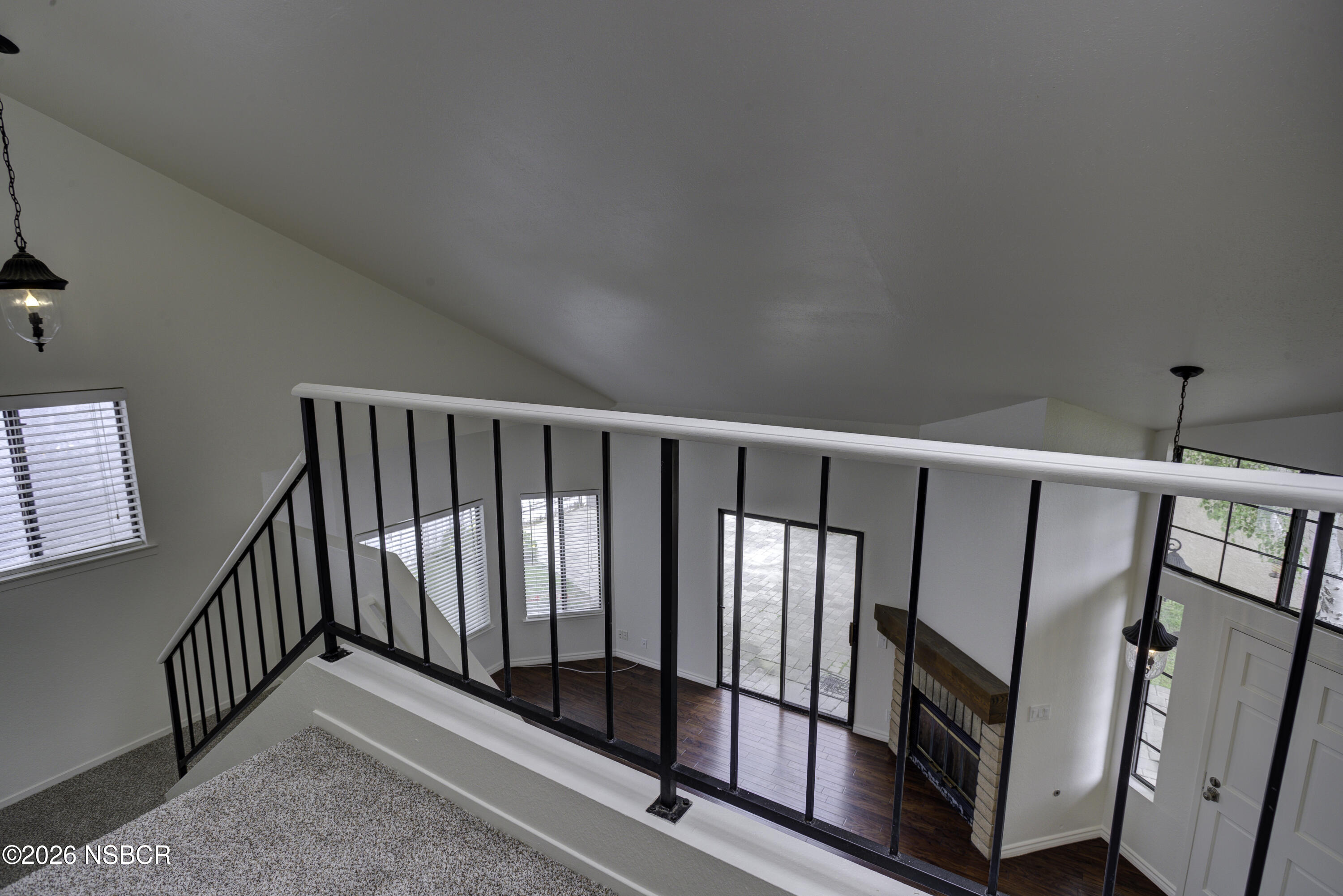 1213 Iris Court Lompoc, CA 93436 - Photo 13 of 21 a view of a hallway with wooden floor and staircase