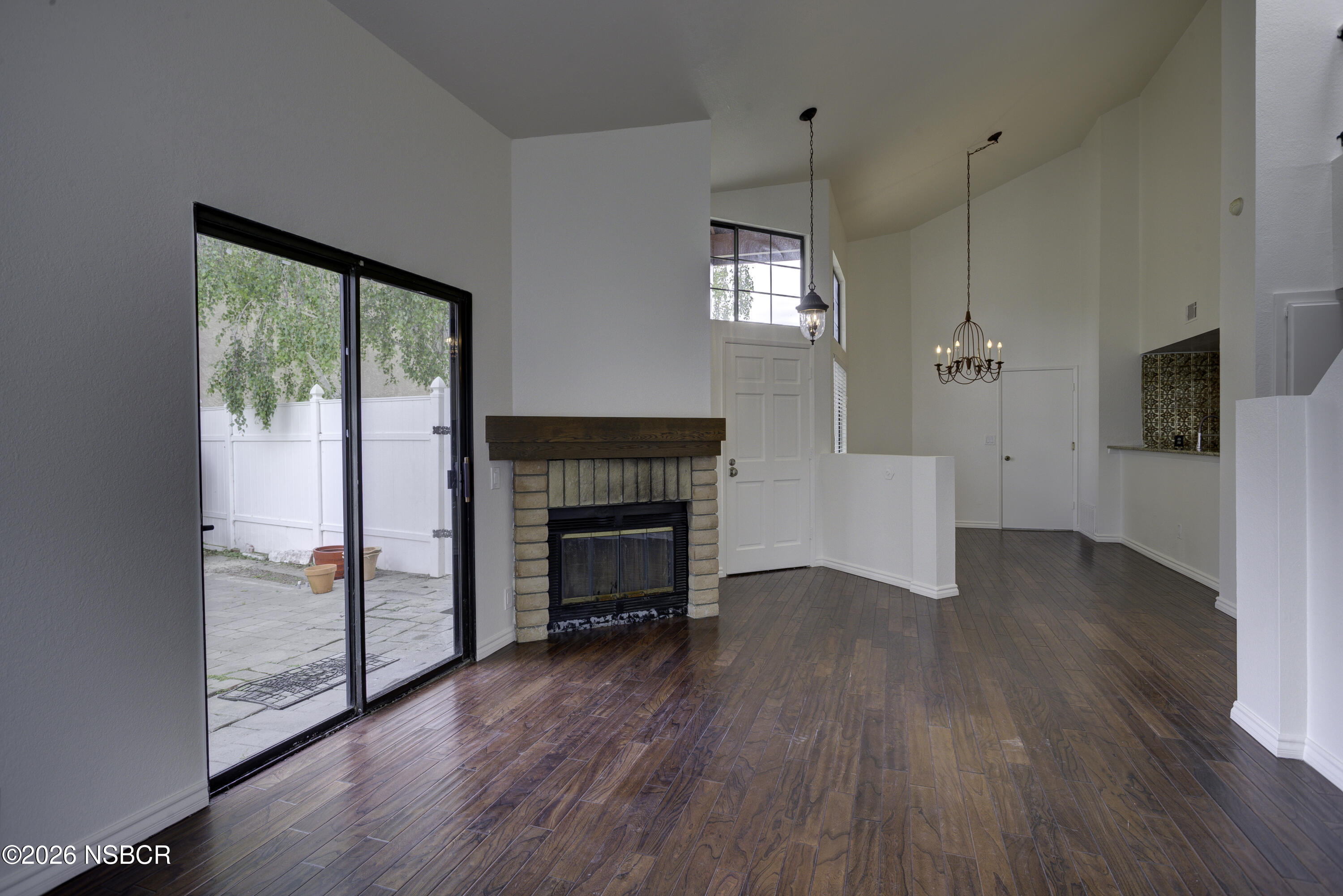 1213 Iris Court Lompoc, CA 93436 - Photo 4 of 21 a view of a livingroom with wooden floor a fireplace and window