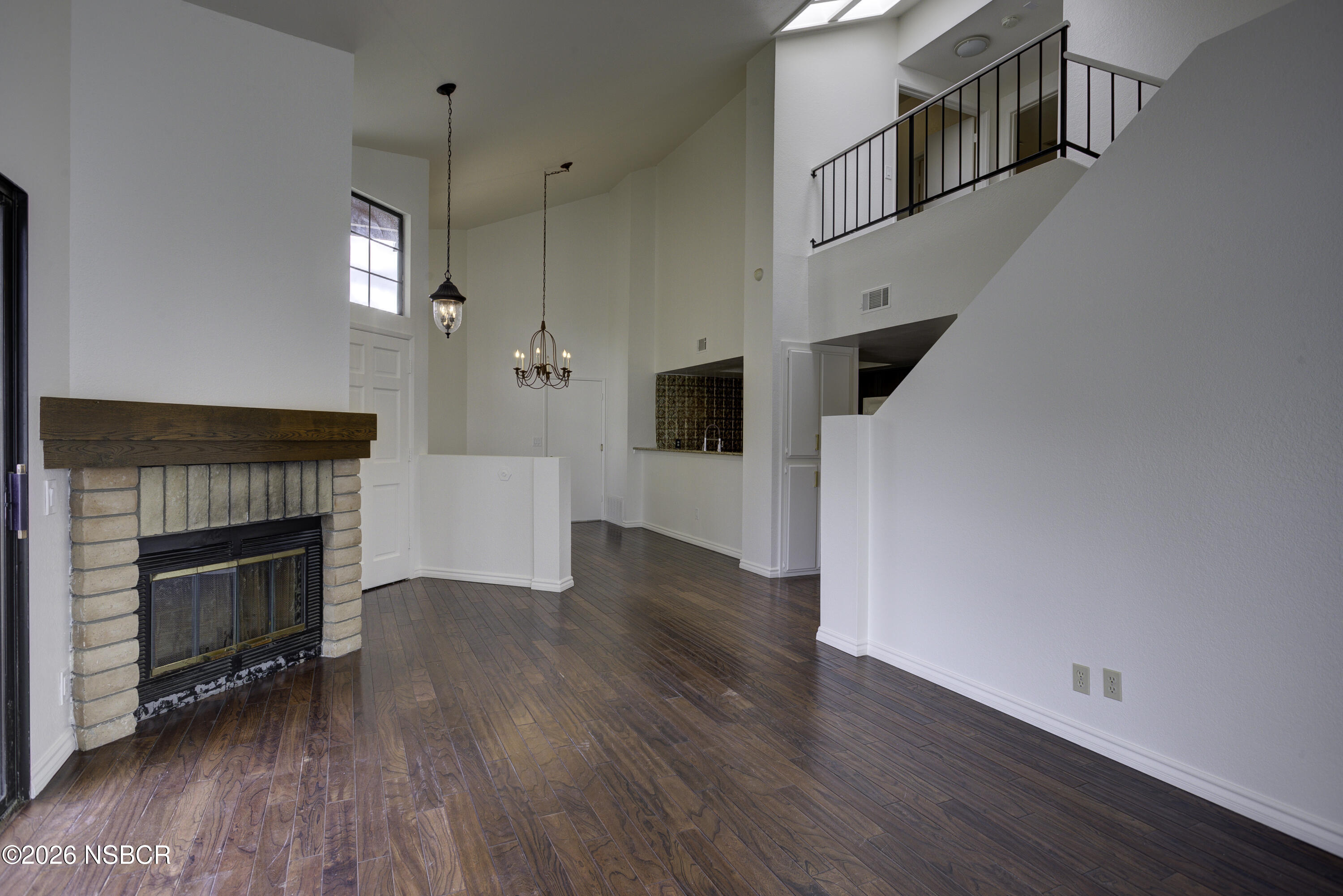 1213 Iris Court Lompoc, CA 93436 - Photo 5 of 21 a view of a livingroom with wooden floor and a fireplace