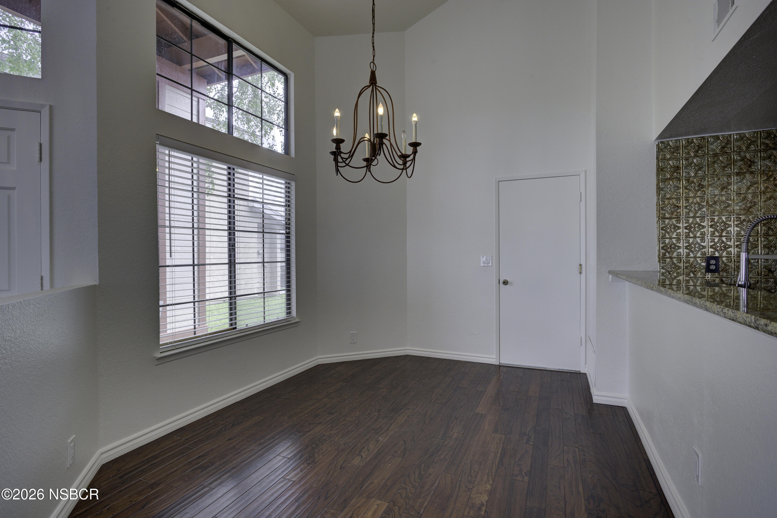 1213 Iris Court Lompoc, CA 93436 - Photo 6 of 21 a view of an empty room with wooden floor and windows
