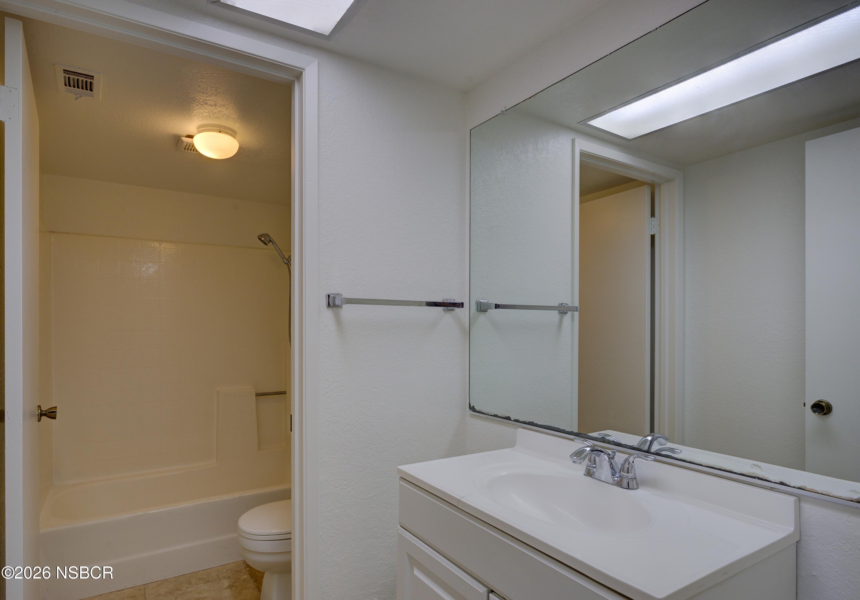 1213 Iris Court Lompoc, CA 93436 - Photo 9 of 21 a bathroom with a sink toilet and shower