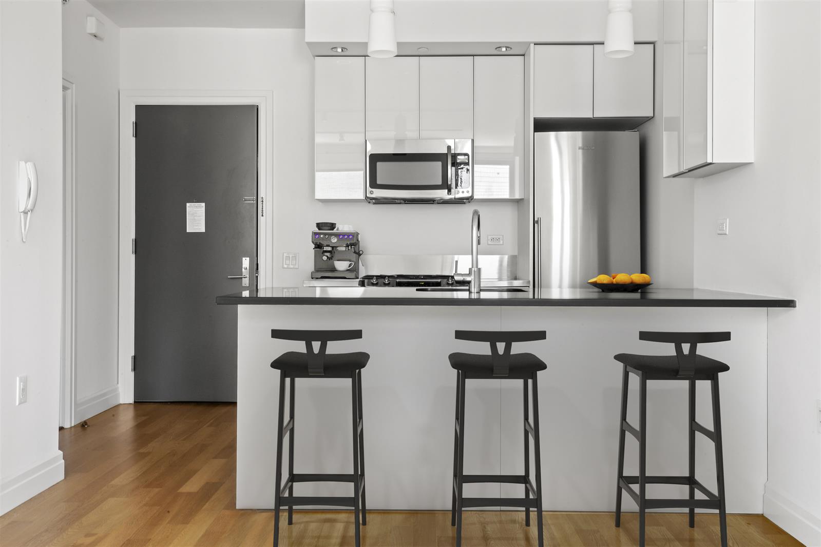 a kitchen with stainless steel appliances a sink cabinets and wooden floor