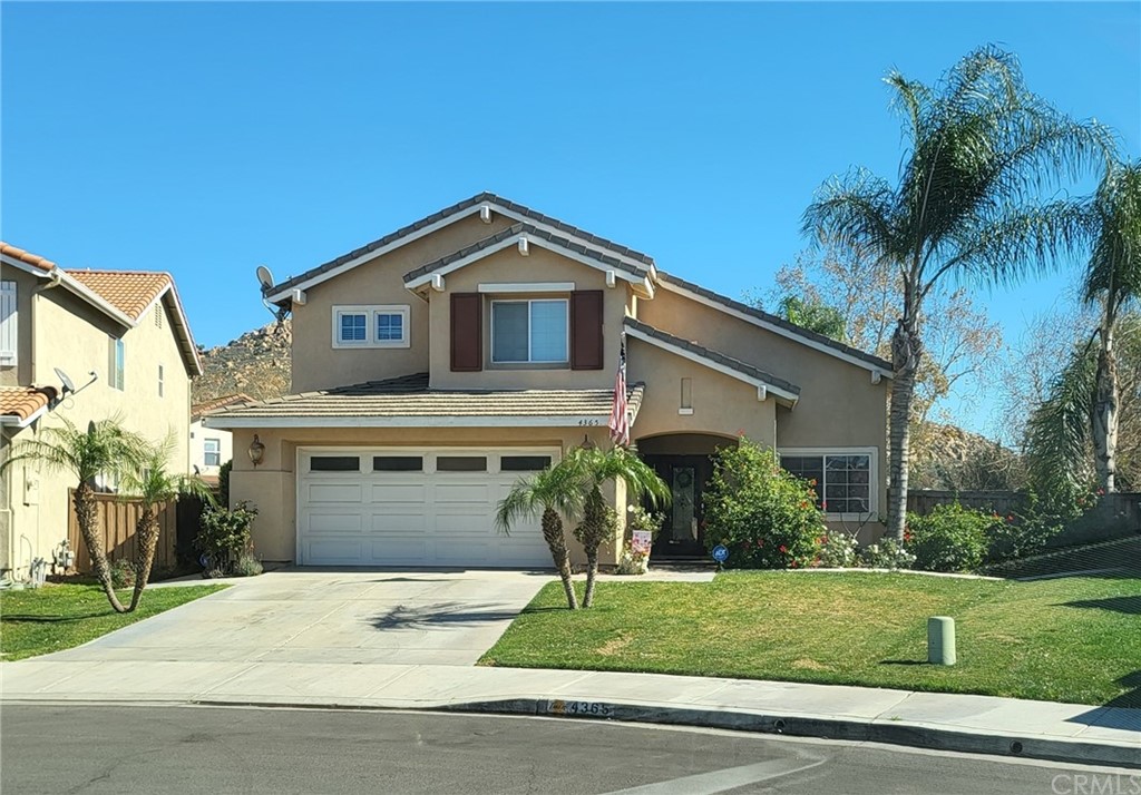 4365 Suffolk Street Riverside, CA 92509 - Photo 1 of 1 a front view of a house with a yard and garage