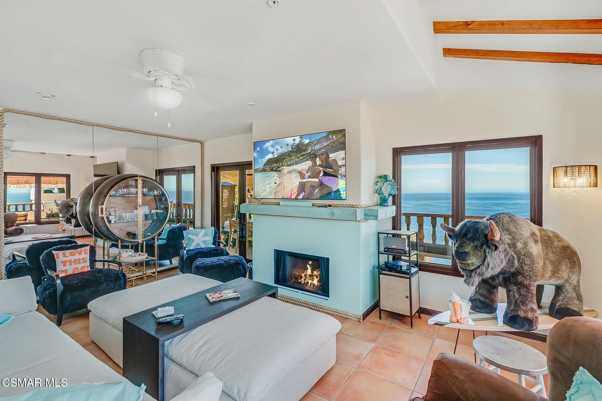 75 Gaviota Avalon, CA 90704 - Photo 13 of 49 a living room with furniture a fireplace and a floor to ceiling window