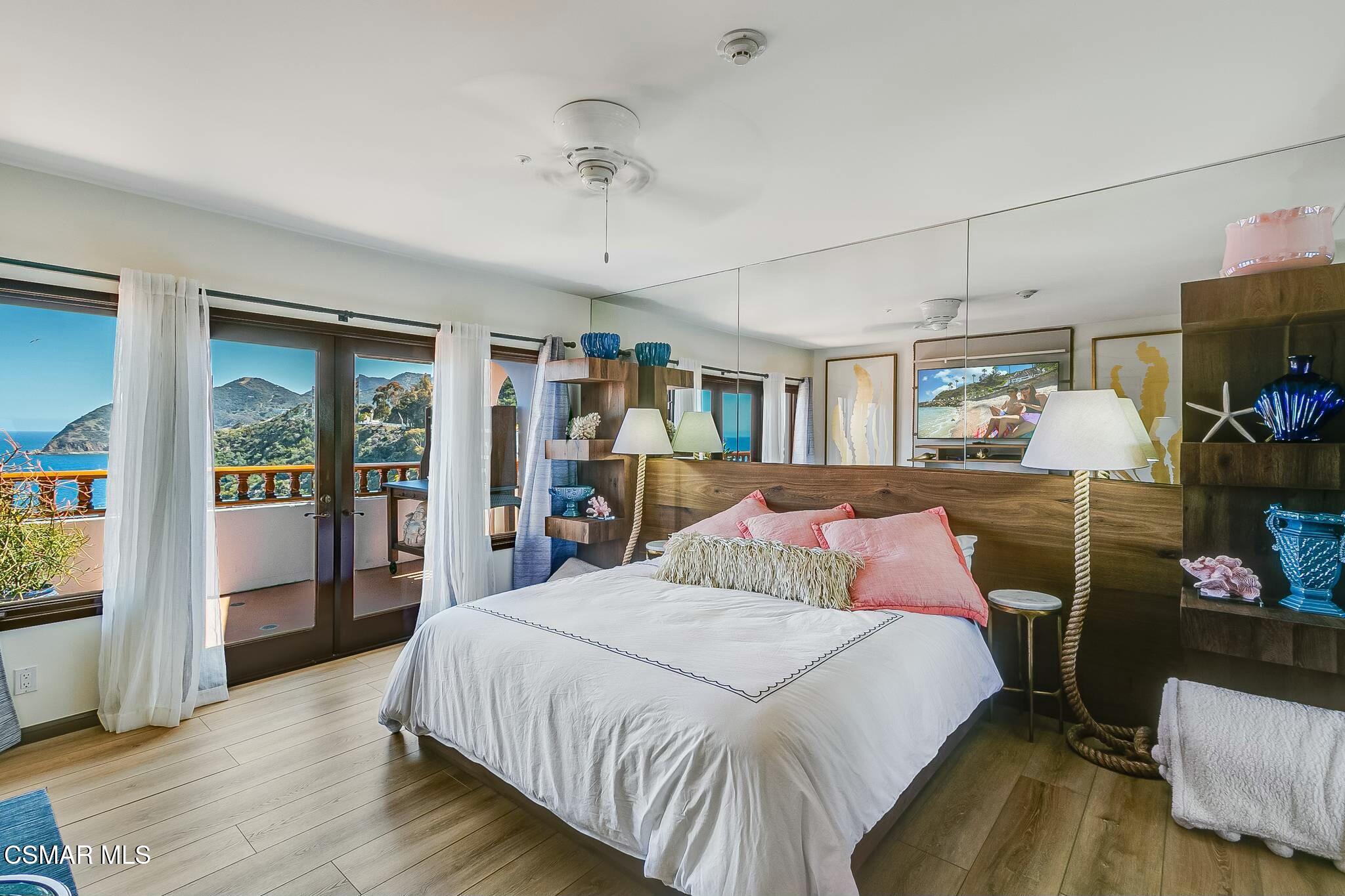 75 Gaviota Avalon, CA 90704 - Photo 21 of 49 a bedroom with a bed a flat screen tv and balcony