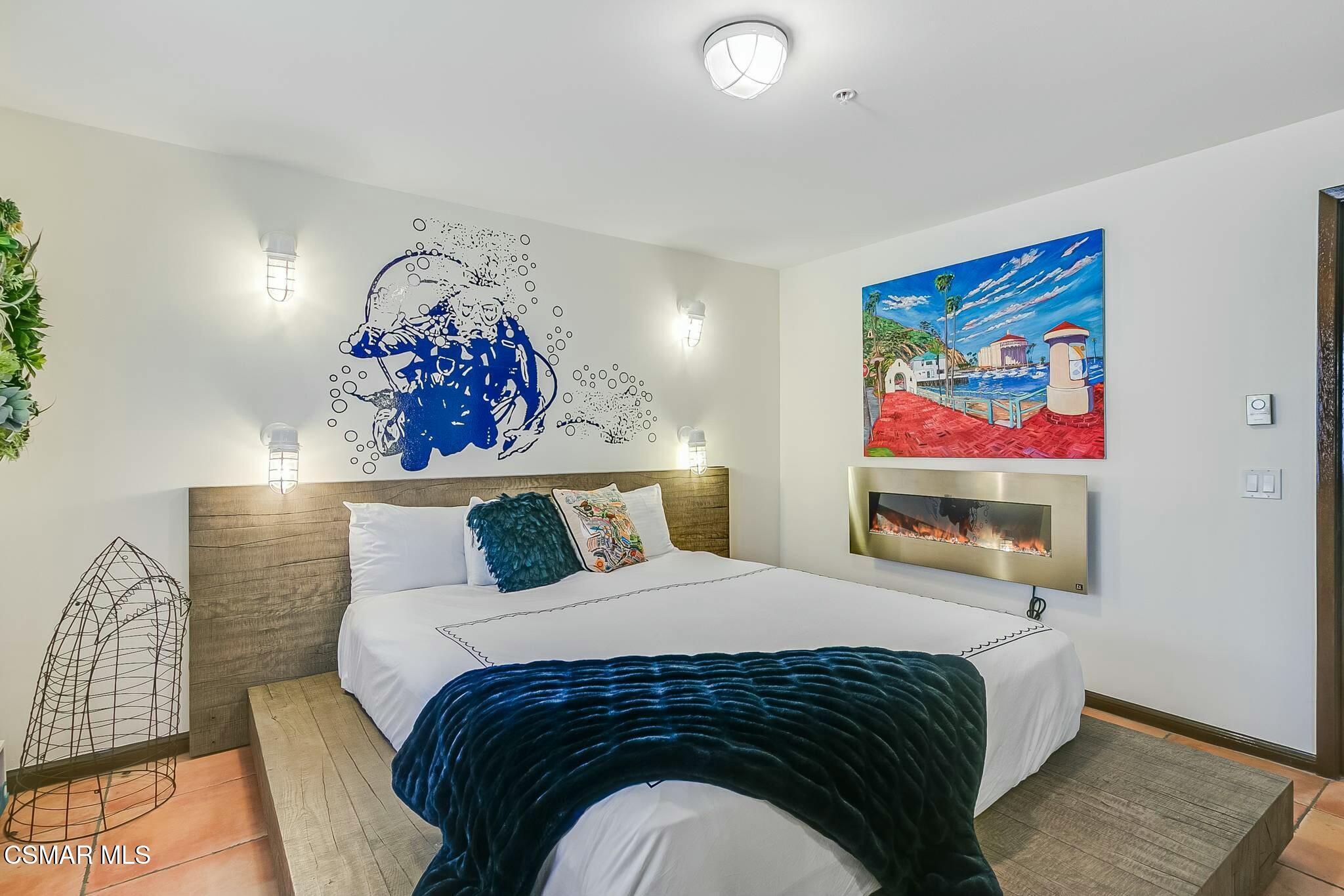 75 Gaviota Avalon, CA 90704 - Photo 31 of 49 a bedroom with a bed and a painting on the wall