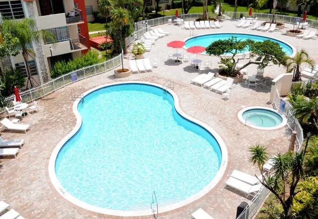 a view of a swimming pool with outdoor seating