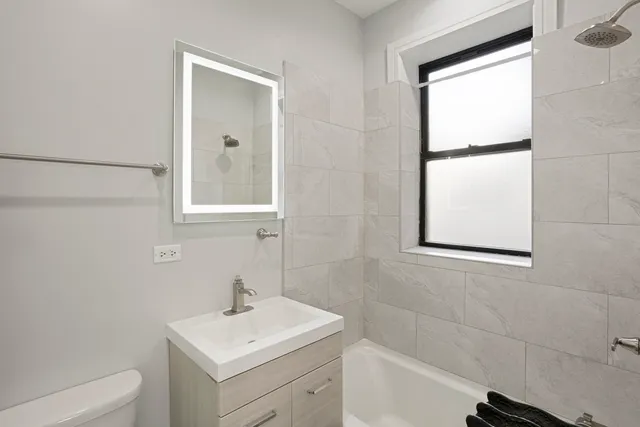 a bathroom with a sink toilet and vanity