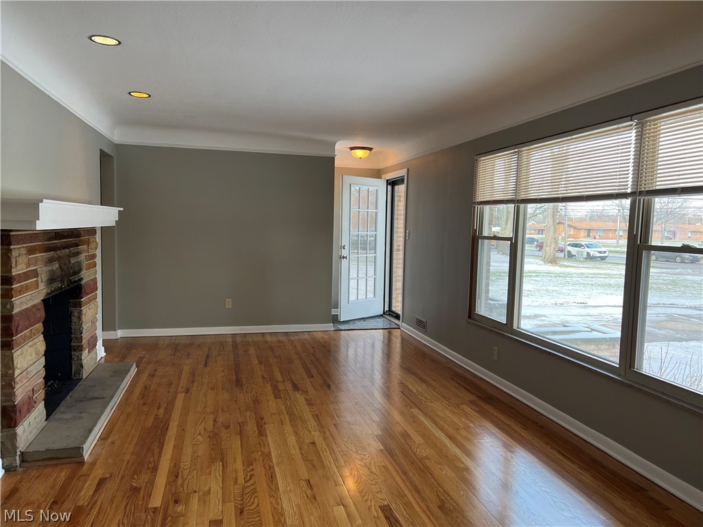 6916 York Road Parma Heights, OH 44130 - Photo 2 of 17 Welcoming Living Room with Gleaming Hardwood Floors throughout Main Floor, Wood Burning Fireplace