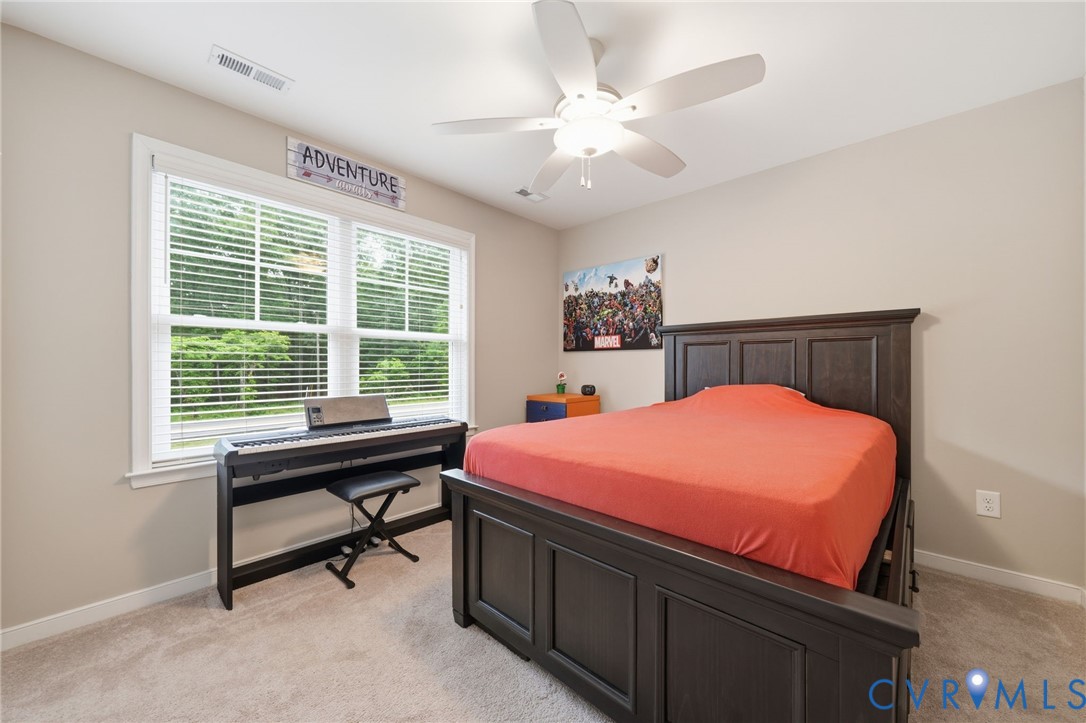 7598 Rural Point Road Mechanicsville, VA 23116 - Photo 29 of 41 a bed room with a bed and a table