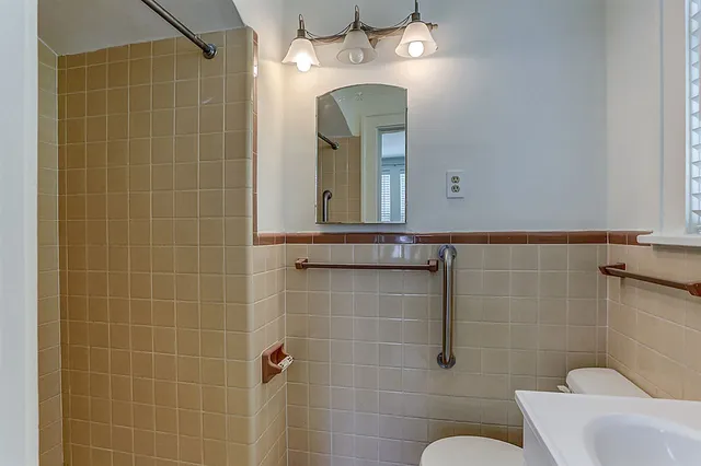a bathroom with a toilet sink and shower