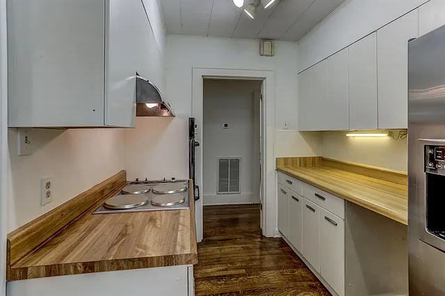 a kitchen with a stove and a white refrigerator