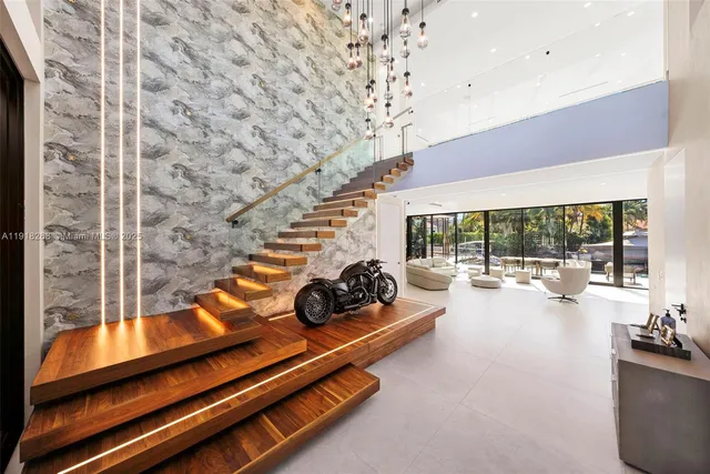 a room with lots of tables a large window and couch