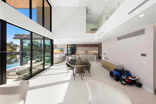 a bedroom with a large bed and a flat tv screen on dresser