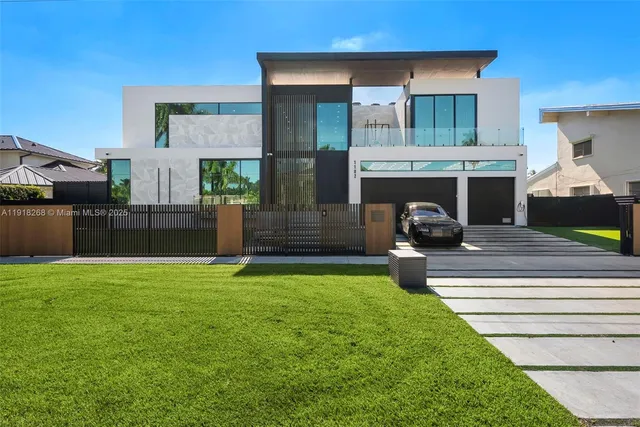 a dining room with furniture large windows and a chandelier